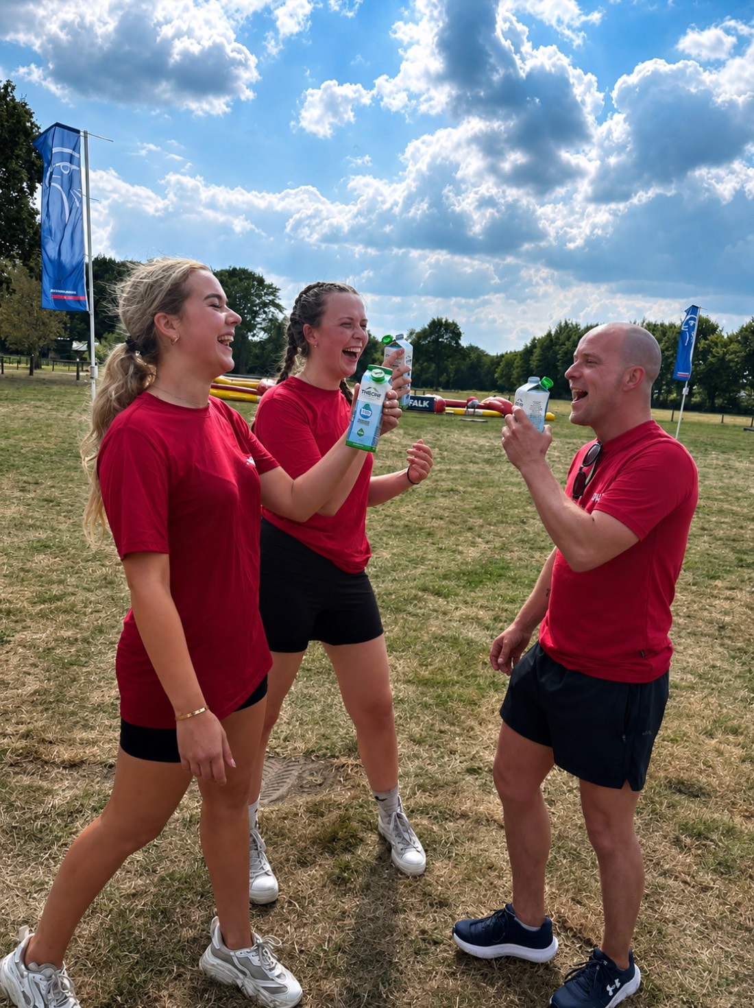 Deelnemers van een sportevenement proosten met pakken THEONI